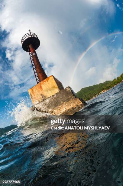 lighthouse & rainbow - lighthouse reef stock pictures, royalty-free photos & images