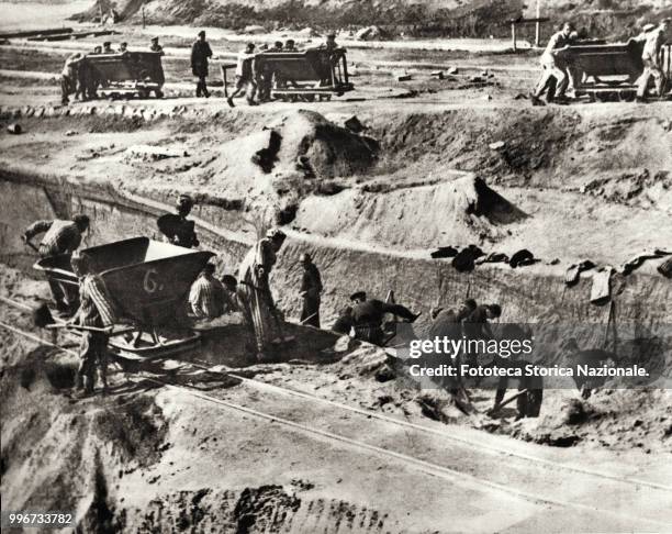 Workers forced to build the concentration and extermination camp at Mauthausen, the camp was opened on August 8, 1938; intellectuals and opponents of...