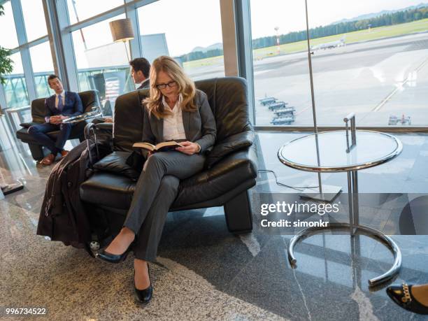 business people sitting on chair at airport - airport business lounge stock pictures, royalty-free photos & images