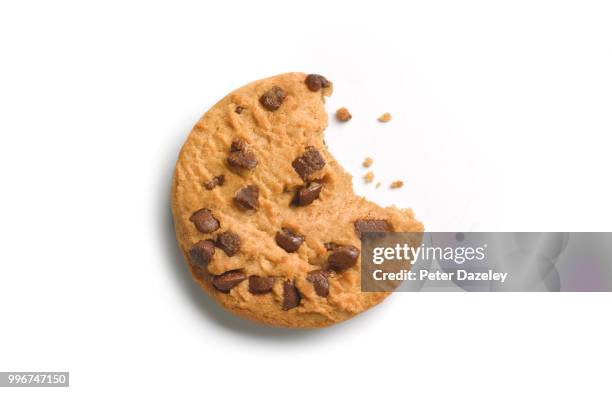 chocolate chip cookie with bite out - biscuit stockfoto's en -beelden