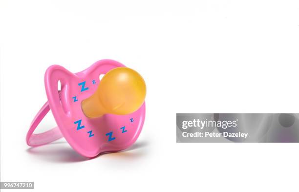 pink dummy with copy space and zzz - pacifier stockfoto's en -beelden