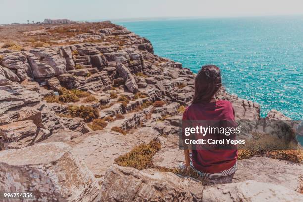 young woman  girl looking out to sea - ot coruña fotografías e imágenes de stock