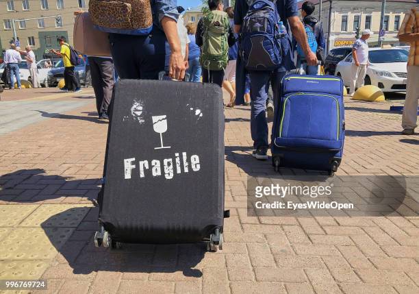 Woman left a sleeper train with a baggage and a logo FRAGILE on July 9, 2018 in Kazan, Russia.