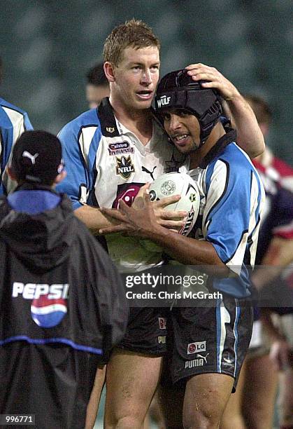 Adam Dykes of the Sharks congratulates Preston Campbell of the Sharks after scoring a try during the round 21 NRL match between the Sydney Roosters...