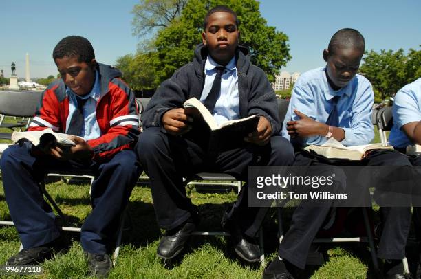 From left, John Ross Siale Scales and David Kadiri of Washington United Christian Academy of Hyattsville, Md., read the Bible before they go on stage...