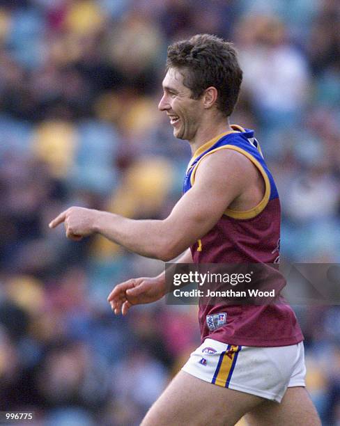 Alastair Lynch of the Lions celebrates a goal during the round 12 AFL match between the Brisbane Lions and the Melbourne Demons played at the Gabba,...