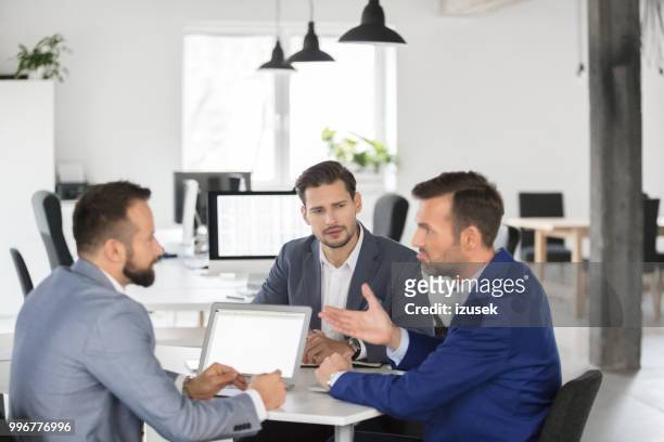 business team brainstorming over new strategy in meeting - izusek stock pictures, royalty-free photos & images