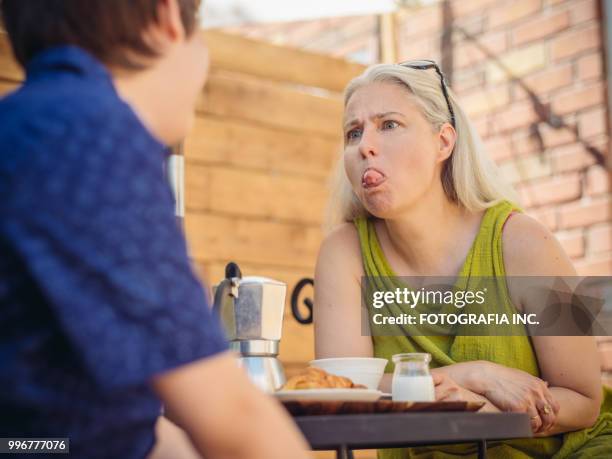 patio time with moter and son - shade45 stock pictures, royalty-free photos & images