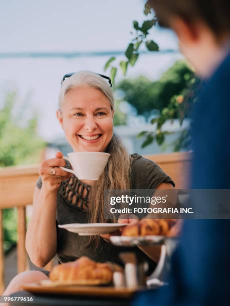 patio time with moter and son - fotografia stock pictures, royalty-free photos & images