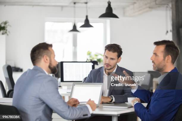 businesspeople having a project meeting in office. - izusek stock pictures, royalty-free photos & images