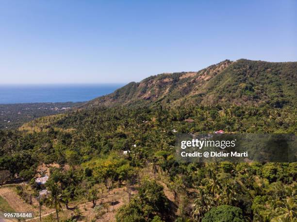 aerial view of bali north coast with mountain and isolated villages in indonesia - didier marti stock pictures, royalty-free photos & images