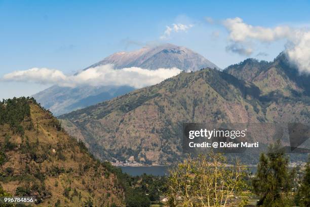 a distant view of the famous agung volcano by the lake batur in mt batur caledra in bali - didier marti stock pictures, royalty-free photos & images