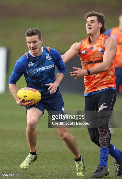Kayne Turner of the Kangaroos and Declan Watson of the Kangaroos compete for the ball during a North Melbourne Kangaroos Training Session on July 12,...