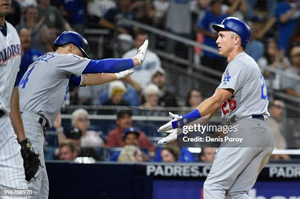 Chase Utley of the Los Angeles Dodgers is congratulated by Enrique Hernandez after scoring during the eighth inning of a baseball game against the...