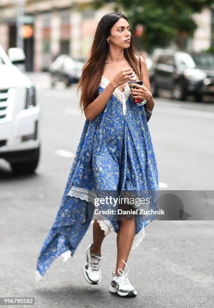 Guest is seen wearing a blue and white dress outside the Death to Tennis show during the 2018 New York City Men's Fashion Week on July 11, 2018 in...