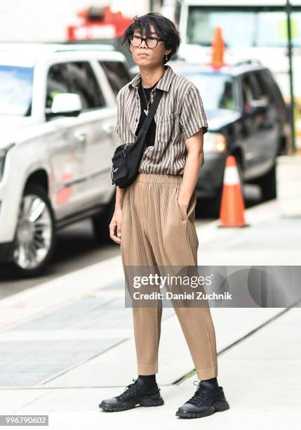 Guest is seen wearing a brown striped shirt and pants outside the Death to Tennis show during the 2018 New York City Men's Fashion Week on July 11,...