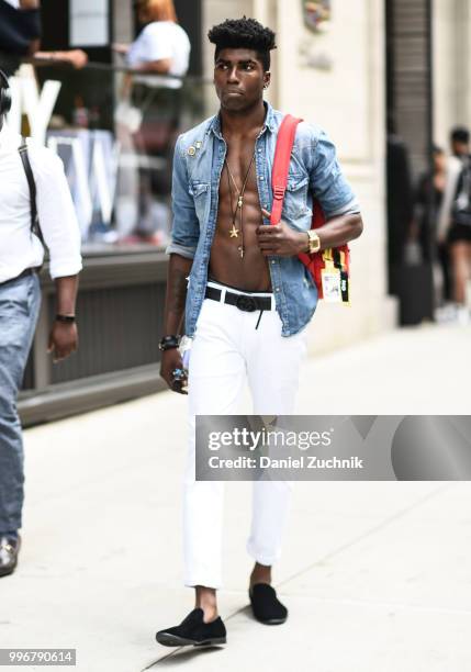 Guest is seen wearing a jean shirt and white pants outside the Death to Tennis show during the 2018 New York City Men's Fashion Week on July 11, 2018...