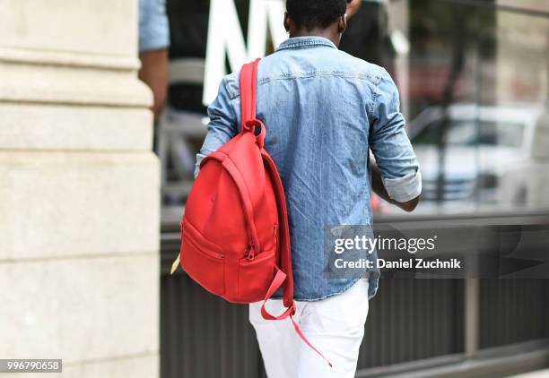 Guest is seen wearing a jean shirt and red bag outside the Death to Tennis show during the 2018 New York City Men's Fashion Week on July 11, 2018 in...