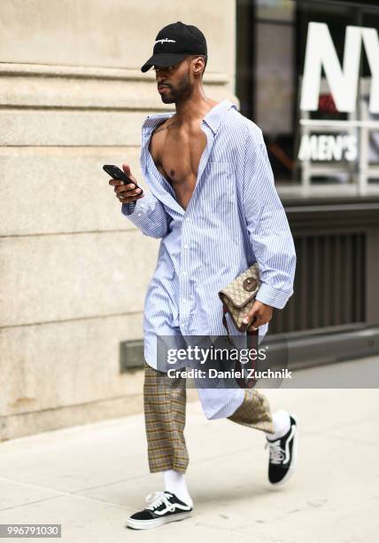 Guest is seen wearing an oversized striped shirt outside the Death to Tennis show during the 2018 New York City Men's Fashion Week on July 11, 2018...