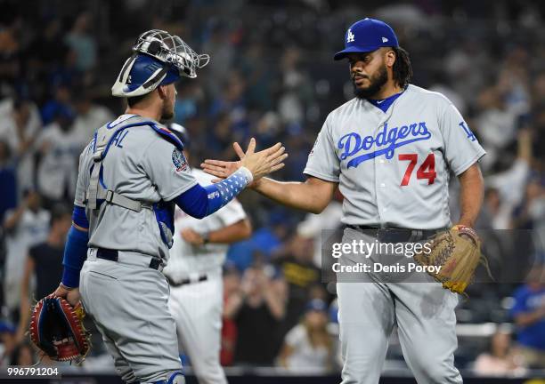 Kenley Jansen of the Los Angeles Dodgers is congratulated by Yasmani Grandal after beating the San Diego Padres 4-2 in a baseball game at PETCO Park...