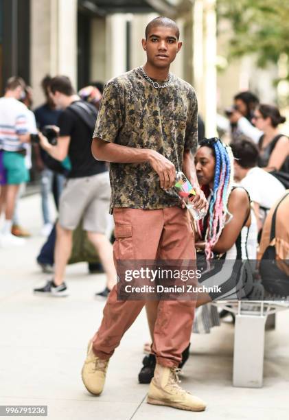Guest is seen wearing a camo t-shirt and pink pants outside the Death to Tennis show during the 2018 New York City Men's Fashion Week on July 11,...