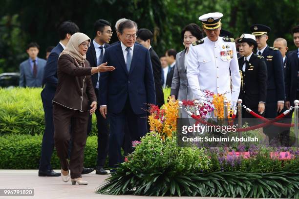 Singapore President, Halimah Yacob gestures to South Korean President, Moon Jae-in during the welcome ceremony at the Istana on July 12, 2018 in...