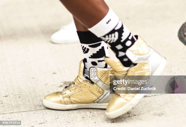 Guest is seen wearing gold sneakers outside the Death to Tennis show during the 2018 New York City Men's Fashion Week on July 11, 2018 in New York...