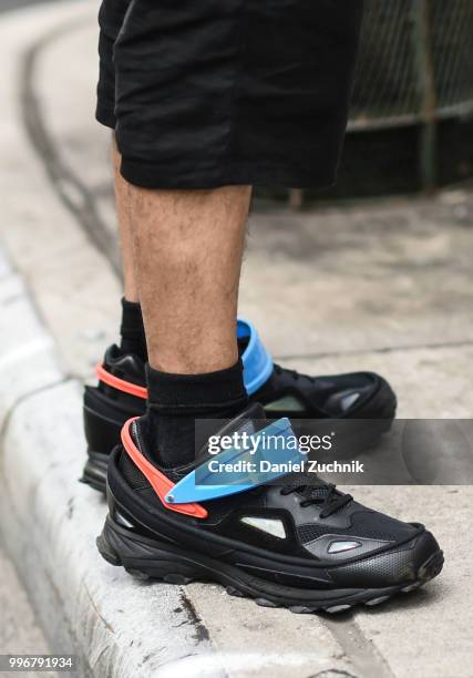 Guest is seen wearing blue and black sneakers outside the Death to Tennis show during the 2018 New York City Men's Fashion Week on July 11, 2018 in...