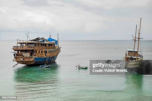 This picture taken on July 7, 2018 shows traditional Pinisi boats moored in Tana Beru, on Indonesia's South Sulawesi island. - The iconic schooners,...