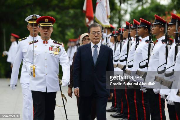 South Korean President, Moon Jae-in inspects the guard of honour, accompanied by Singapore President, Halimah Yacob during the welcome ceremony at...