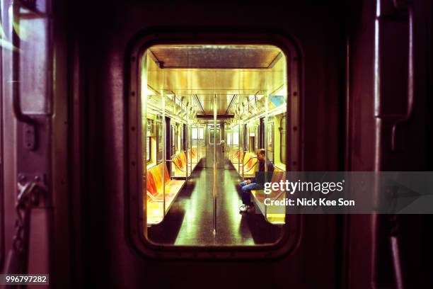 man rides alone in an empty subway car - metro north railroad stock pictures, royalty-free photos & images