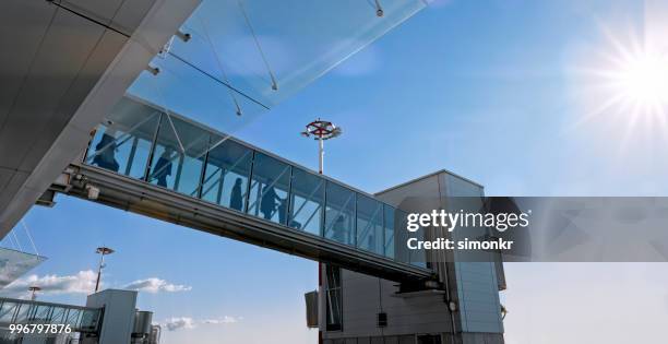 people walking on elevated walkway - pedestrian walkway stock pictures, royalty-free photos & images