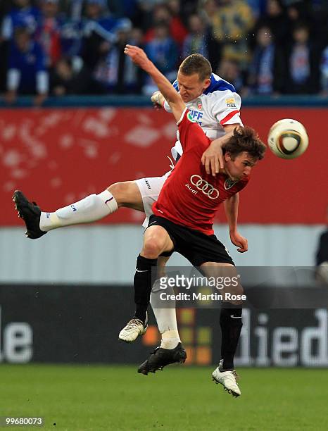 Enrico Kern of Rostock and Andreas Buchner of Ingolstadt head for the ball for the ball during the Second Bundesliga play off leg two match between...
