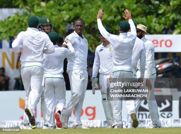 South African cricketer Kagiso Rabada celebrates with his teammates after he dismissed Sri Lankan cricketer Danushka Gunathilaka during the first day...