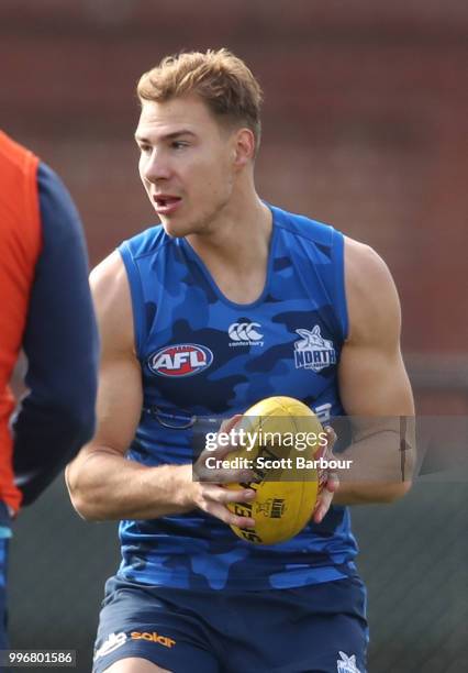 Ben McKay of the Kangaroos runs with the ball during a North Melbourne Kangaroos Training Session on July 12, 2018 in Melbourne, Australia.