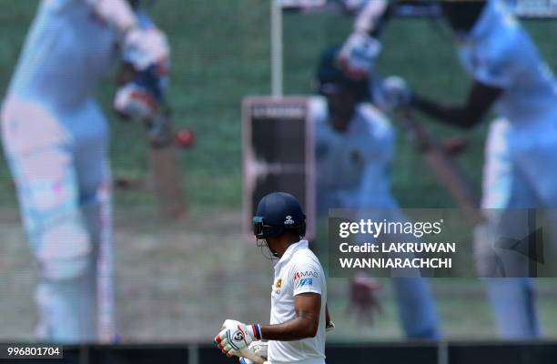 Sri Lankan cricketer Danushka Gunathilaka walks back to the pavilion after his dismissal during the first day of their opening Test match between Sri...