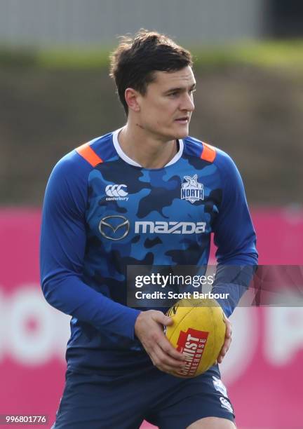 Scott Thompson of the Kangaroos runs with the ball during a North Melbourne Kangaroos Training Session on July 12, 2018 in Melbourne, Australia.