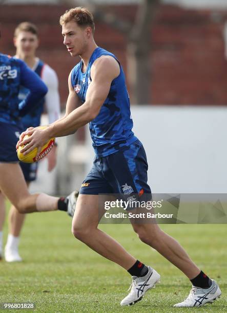 Ben McKay of the Kangaroos runs with the ball during a North Melbourne Kangaroos Training Session on July 12, 2018 in Melbourne, Australia.