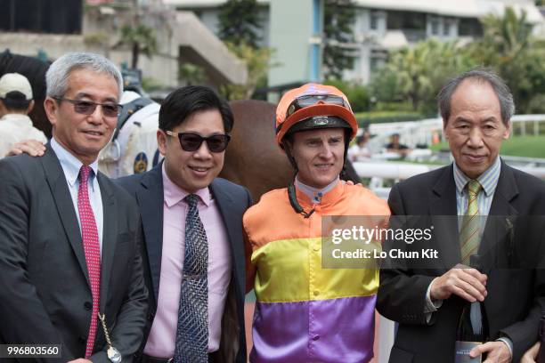 Jockey Zac Purton, trainer Dennis Yip Chor-hong and owner Pang Yuen Hing celebrate after On The Way winning Race 1 Guildford Handicap at Sha Tin...