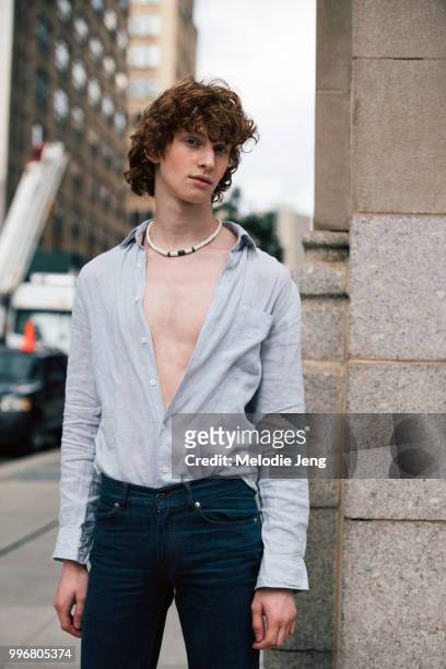 Model Simon Lieber wears a shirt unbottoned and jeans during New York Fashion Week Mens Spring/Summer 2019 on July 11, 2018 in New York City.