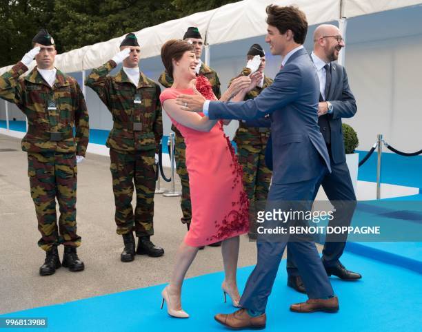 Michel's partner Amelie Derbaudrenghien, Prime Minister of Canada Justin Trudeau and Belgian Prime Minister Charles Michel greet each other as they...