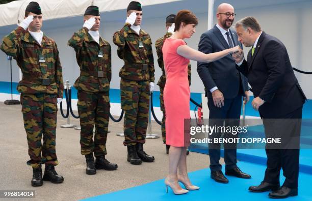 Michel's partner Amelie Derbaudrenghien, Belgian Prime Minister Charles Michel and Hungary Prime Minister Viktor Orban greet each other as they...