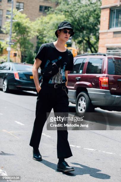 Model Julian Weigl in a black bucket hat and Prada fannypack during New York Fashion Week Mens Spring/Summer 2019 on July 11, 2018 in New York City.