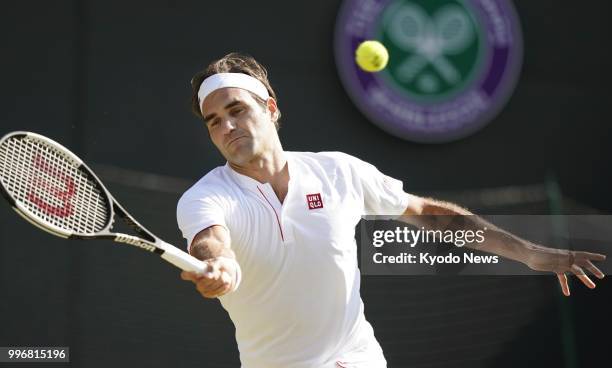 Roger Federer of Switzerland hits the ball during a quarterfinal match against Kevin Anderson of South Africa at Wimbledon in London on July 11,...