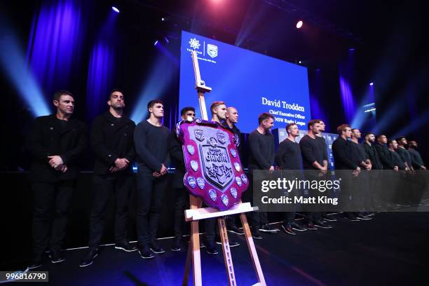 The State of Origin shield is seen with Blues players lined up on stage during a New South Wales Blues public reception after winning the 2018 State...