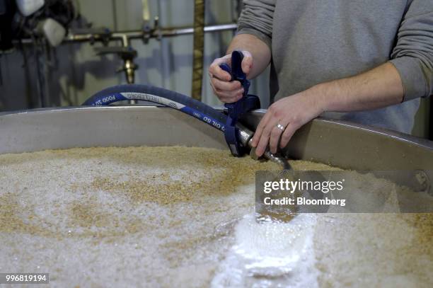 An employee releases carbon dioxide into a fermentation vat of barley at the Lark Distillery Ltd. Whisky and gin distillery in Cambridge, Tasmania,...