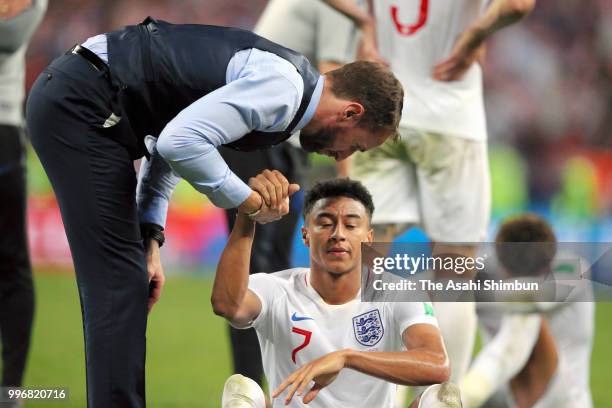 Jesse Lingard of England is consoled by manager Gareth Southgate after their 1-2 defeat in the 2018 FIFA World Cup Russia Semi Final match between...