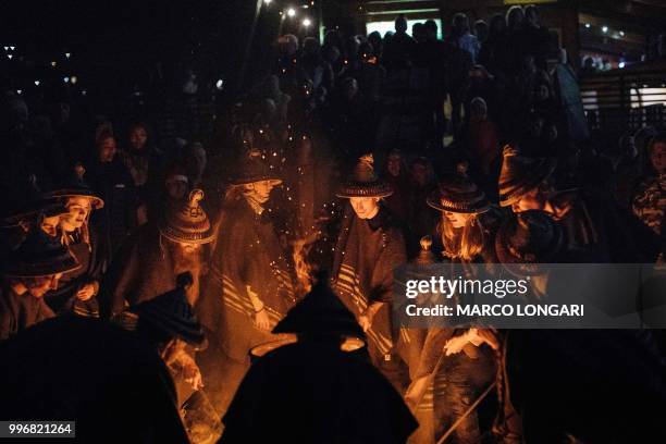 Ski instructors dressed in traditional Basotho attire dance around a bone fire at the end of a torchlight procession from the top of the main 1km...