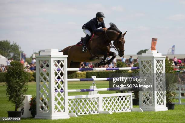 Participant seen riding a horse while jumping over an obstacle during the Great Yorkshire Show 2018 on day one. The Great Yorkshire Show is the...