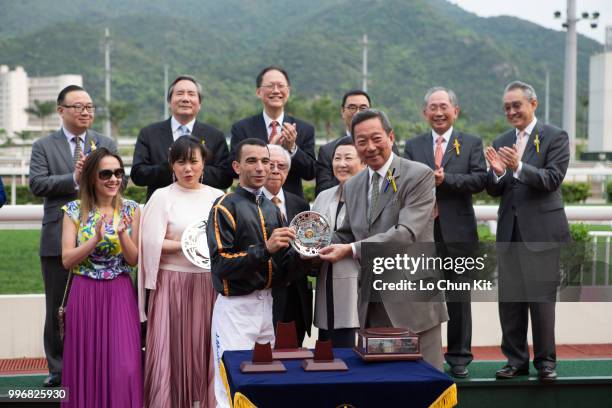 Jockey Joao Moreira receives the trophy after Able Friend winning Race 7 The Chairman's Trophy at Sha Tin racecourse on April 7 , 2015 in Hong Kong.